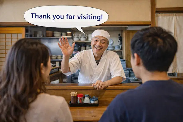 蕎麦屋の店主がカウンター越しに外国人観光客へ笑顔で手を振る様子。ひたちなか市のインバウンド対応における温かいおもてなしを表現した場面
